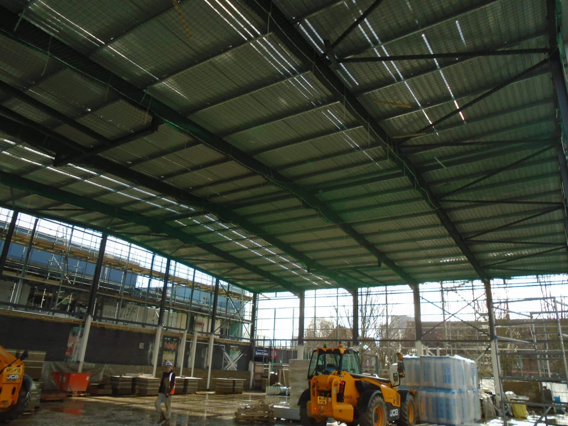 Roof steelwork of a large building seen from below
