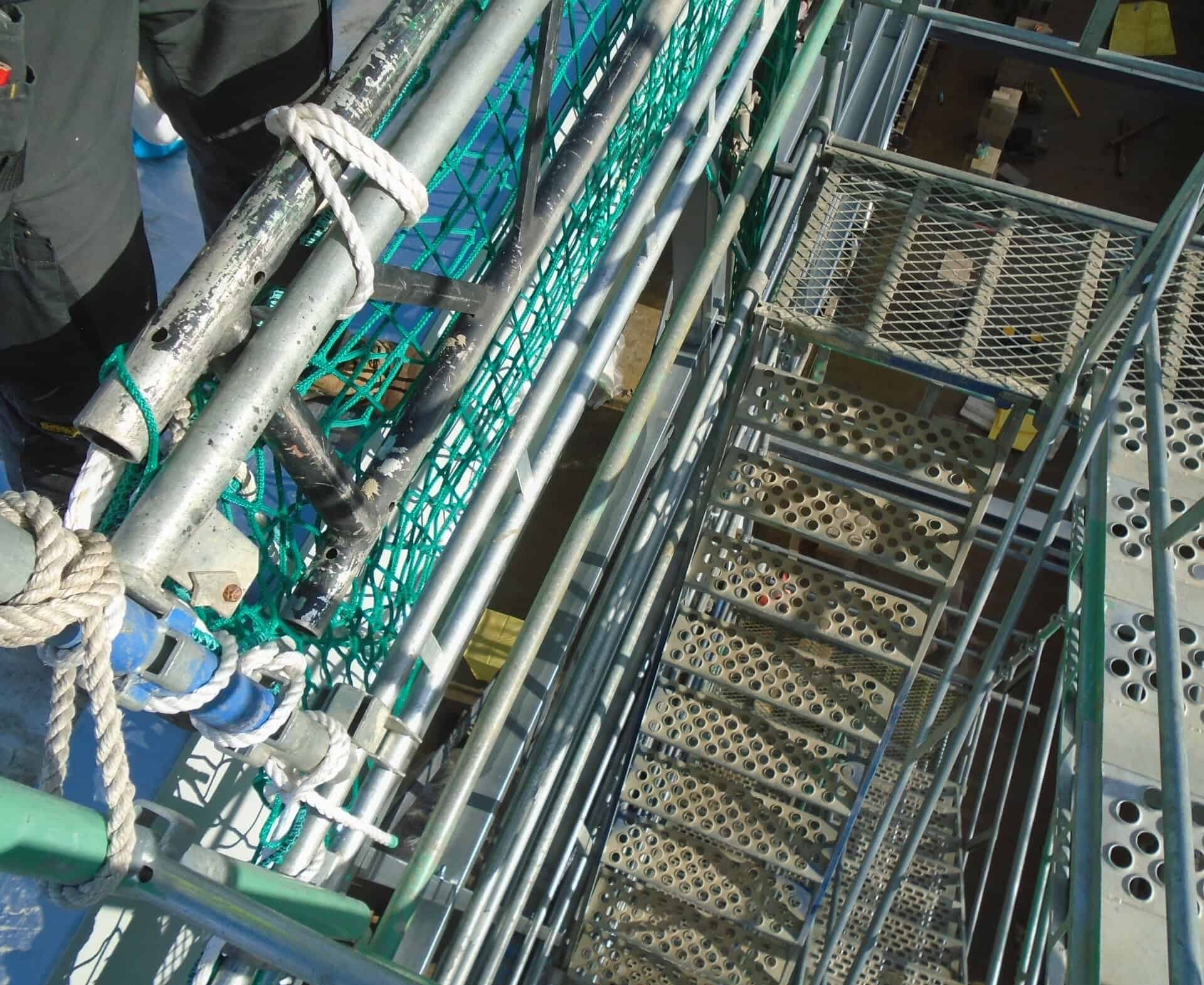Stair tower with safety netting and rope alongside