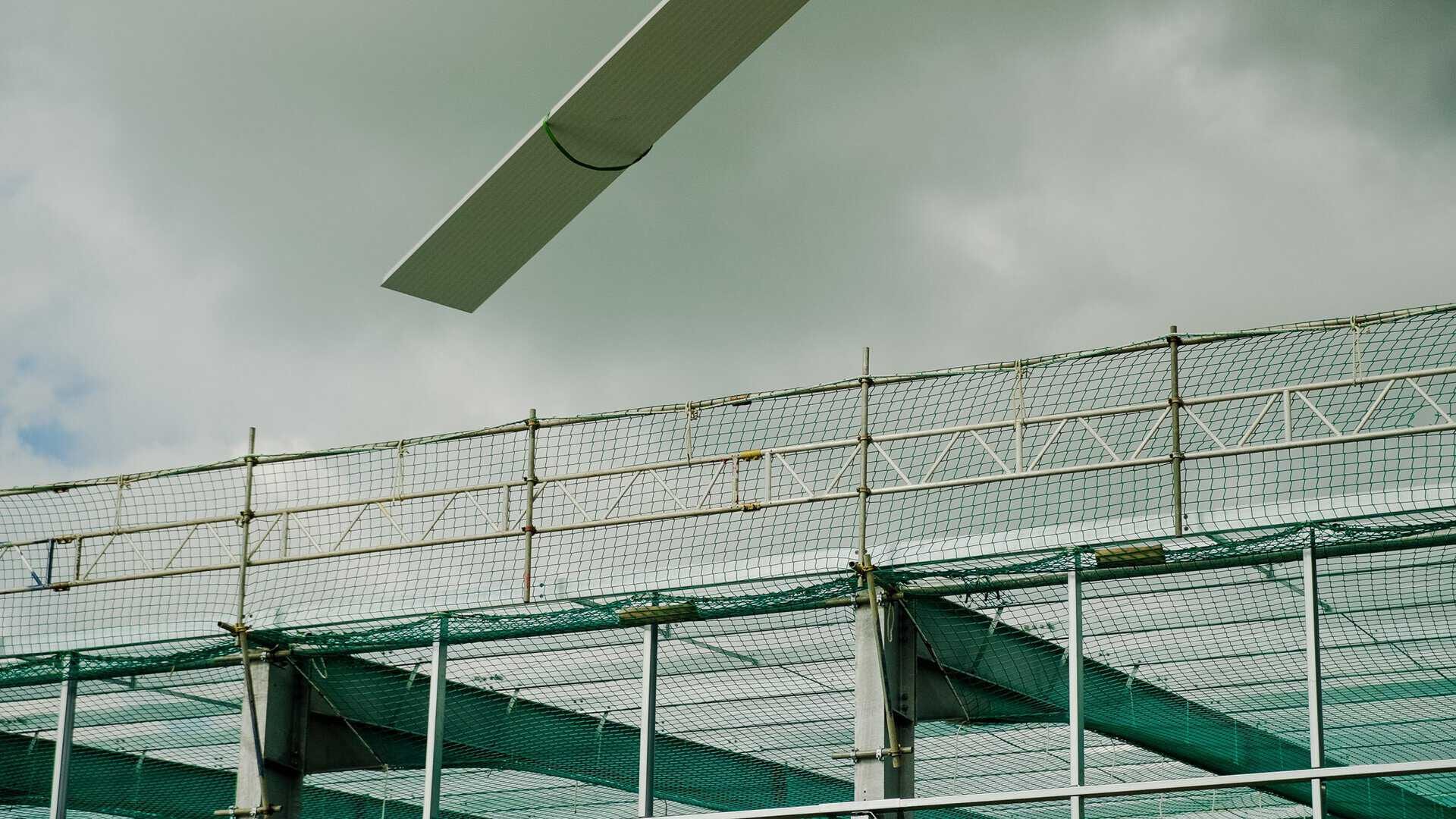 Safety netting rigged at the edge of roof steelwork